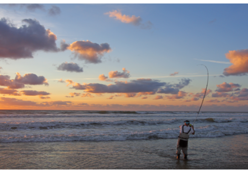 angler casting from the surf