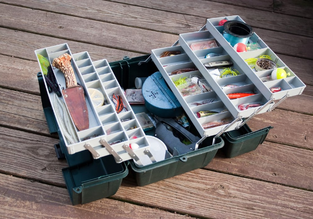 open fishing tackle box on plank