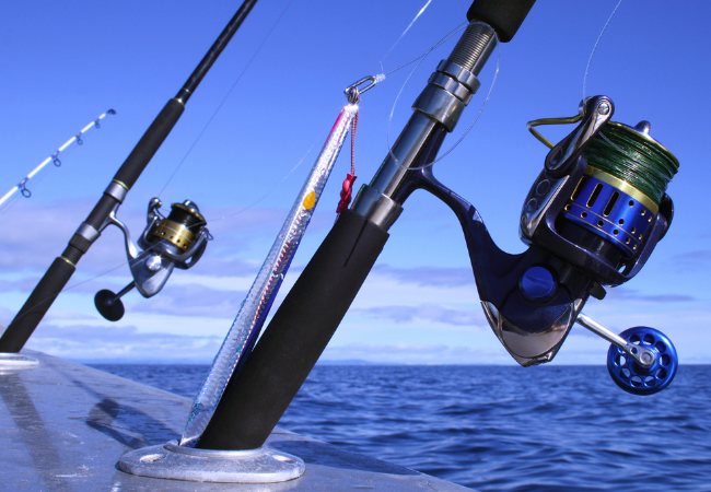 spinning reels and rods on boat spread in the middle of the ocean